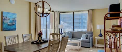 Dining area with living area in the background & balcony access