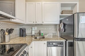 Renovated kitchen with stainless steel appliances.