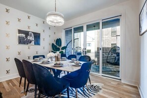 Elevate your dining experience with this chic setup featuring blue chairs and a white table.