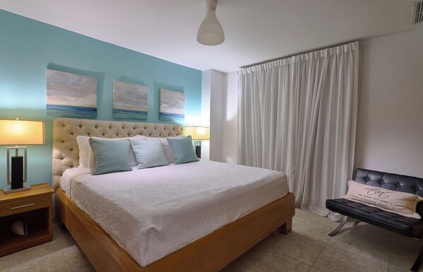 Main room with king bed, A/C, and TV for maximum comfort.