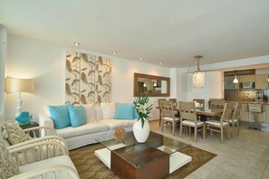 Spacious living room and balcony with stunning 3rd-floor beach views, plus Smart TV for your entertainment.