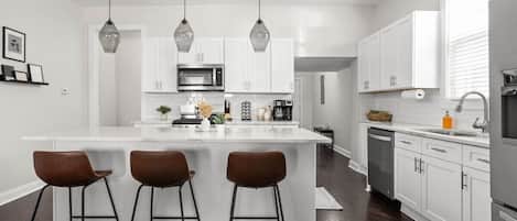 Our inviting kitchen, designed with a spacious countertop for both food preparation and dining.