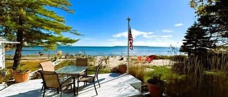 Waterfront deck off master bedroom with seating overlooking Mackinac Island