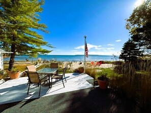 Waterfront deck off master bedroom with seating overlooking Mackinac Island