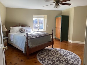 Primary bedroom with queen bed and sunny southern exposure!