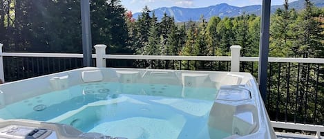 "Escape to serenity with our hot tub, where the soothing waters and breathtaking mountain views combine to create a truly magical experience. Whether you're unwinding after a day of adventure or simply enjoying a peaceful moment, our hot tub offers the pe