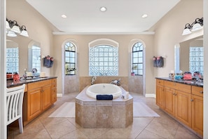 Primary bathroom with double vanities, walk-in shower and soaking tub