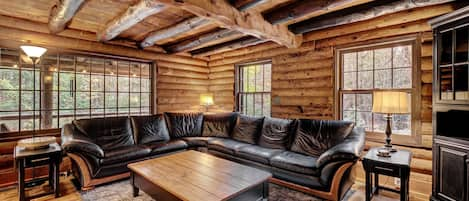 Gorgeous log cabin with exposed log trusswork and original pine floors