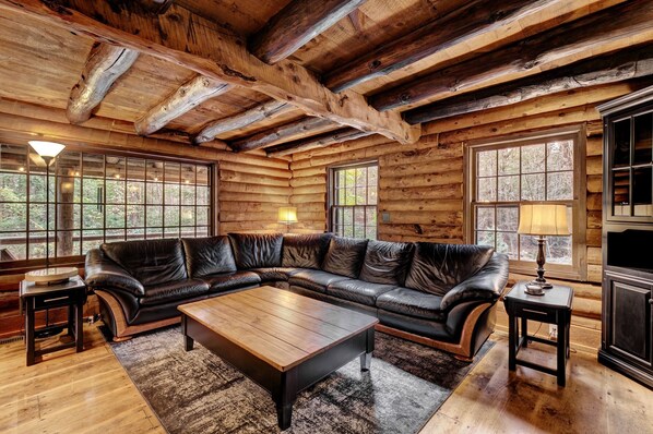 Gorgeous log cabin with exposed log trusswork and original pine floors