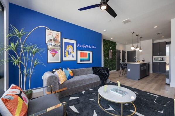 Bright open concept living area with floor to ceiling windows providing panoramic views of Midtown! Features designer furniture and smart TV!
