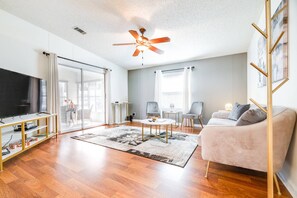 Spacious living area with a sliding glass door for entry into the outdoor patio!