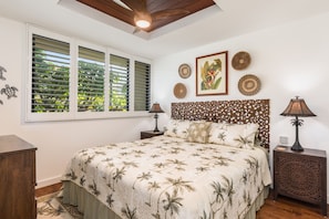 The tropical themed guest bedroom features a king bed. Split AC systems in both bedrooms.