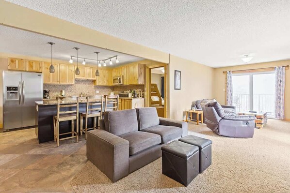 Large living area with seating and open kitchen