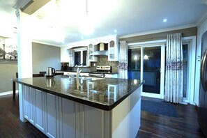 Kitchen with amazing view to the back yard and public park.