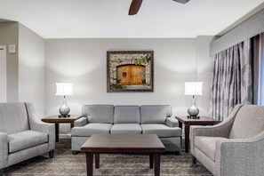 Living room features a sleeper sofa for two and a flat screen TV.