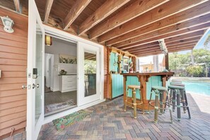 The French doors next to the bar will lead you into Flora Cottage.