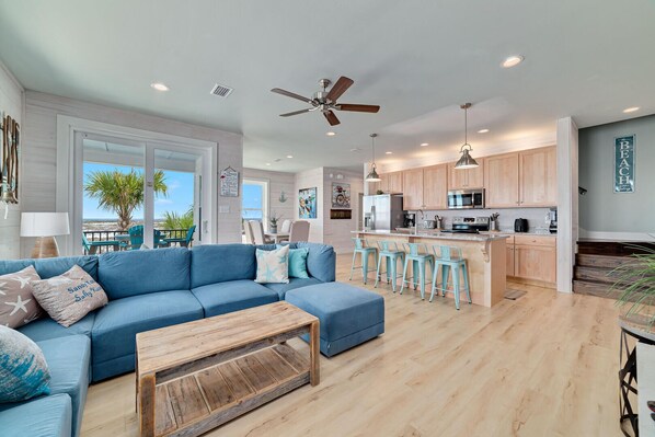 The living area seamlessly merges with the kitchen, creating a dynamic space where enjoying meals converges with relaxation to foster a sense of togetherness and comfort.