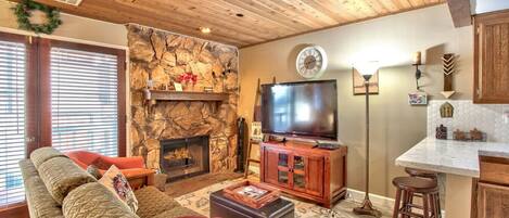 This living room has a cozy stone fireplace.