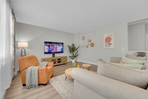 1st Floor family room with cozy sofa, chair & smart TV