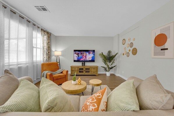 1st Floor family room with cozy sofa, chair & smart TV