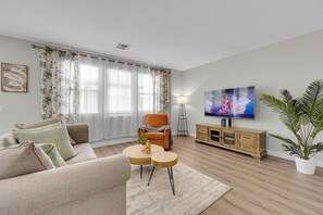 1st Floor family room with cozy sofa, chair & smart TV