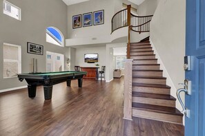 Elegance Meets Entertainment: Billiard Room and Stylish Stairs