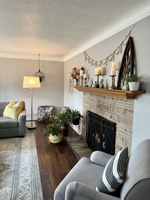 Cozy living room with large picture windows. Note:  fireplace is not operational