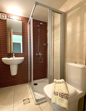 Full bathroom with shower located on the ground floor of the villa.