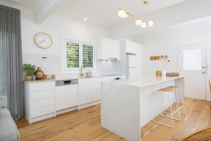 A stylish new kitchen comes equipped for all your holiday catering with a breakfast bar for slow mornings at home.