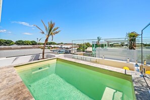 Cool off in the glistening rooftop swimming pool, while taking in neighbourhood views.
