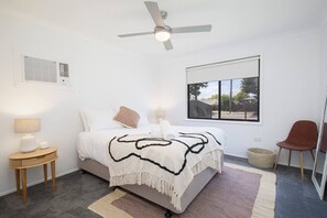 The bright and spacious main bedroom offers a queen-size bed