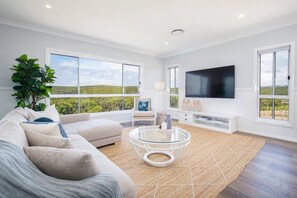 The main lounge area upstairs features comfy sofas, where guests can kick back and watch a TV.