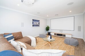 A theatre room downstairs offers an enjoyable entertaining space for guests.
