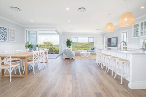 Upstairs, a light and airy open-plan layout includes ample space to dine and relax.