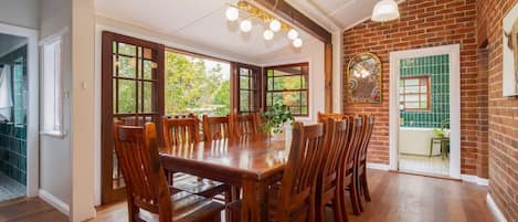 Come together for a meal at home thanks to a grand wooden dining table.
