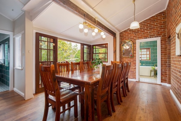 Come together for a meal at home thanks to a grand wooden dining table.
