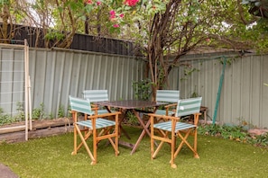 Make use of a private outdoor area, where a cosy four-seater setting offers a peaceful, leafy spot to dine alfresco, and pets are welcome to join in on the fun. 