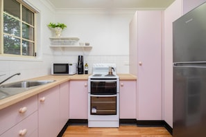 The stylish pink kitchen includes all you need to prepare home-cooked meals when you’re not sampling the array of local cafes and restaurants. 
