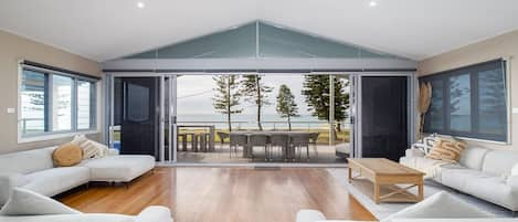 The open plan living space upstairs flows straight to the balcony, capturing natural light and sea breezes.
