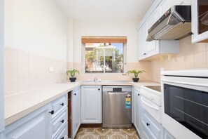 A well equipped kitchen makes it easy to cook up home with a stove, oven and dishwasher.
