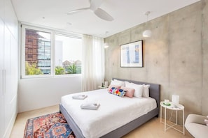 The bedroom features a king bed, ample built-in storage space, and shut-out blinds. With triple-glazed doors and windows throughout, enjoy a good night’s sleep in complete peace and quiet.