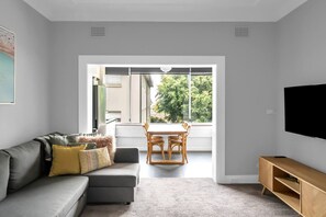 The light-filled dining area includes a four-seater table where guests can share meals together.

