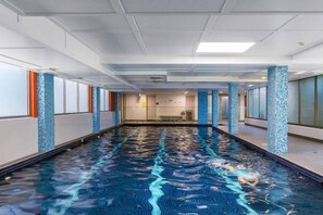 Swim laps in the large indoor pool offered to guests for free within the building. 