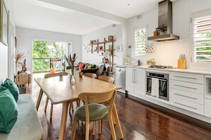 Next to the kitchen you’ll find a four-person wooden dining table where you can enjoy your meals indoors