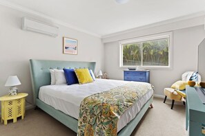 The primary bedroom has a comfortable king size bed to relax amongst soft linen and extra throw pillows. 
