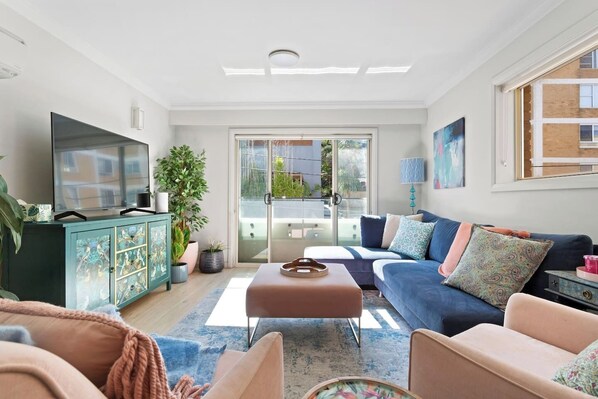 The living room is bright and breezy with sliding doors that open to a balcony bringing in fresh air and sunshine.  

