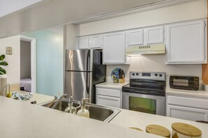 'Fully Equipped Kitchen Featuring Stainless Steel Appliances'