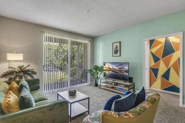 'Comfortable and Contemporary Living Space featuring a Widescreen TV'