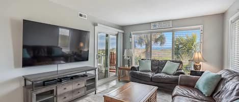 Main living space -- ocean/dune/palm tree views from three sides; 65" TV w/cable