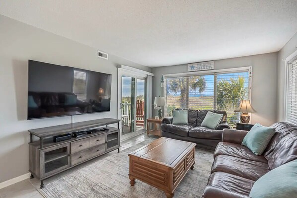 Main living space -- ocean/dune/palm tree views from three sides; 65" TV w/cable